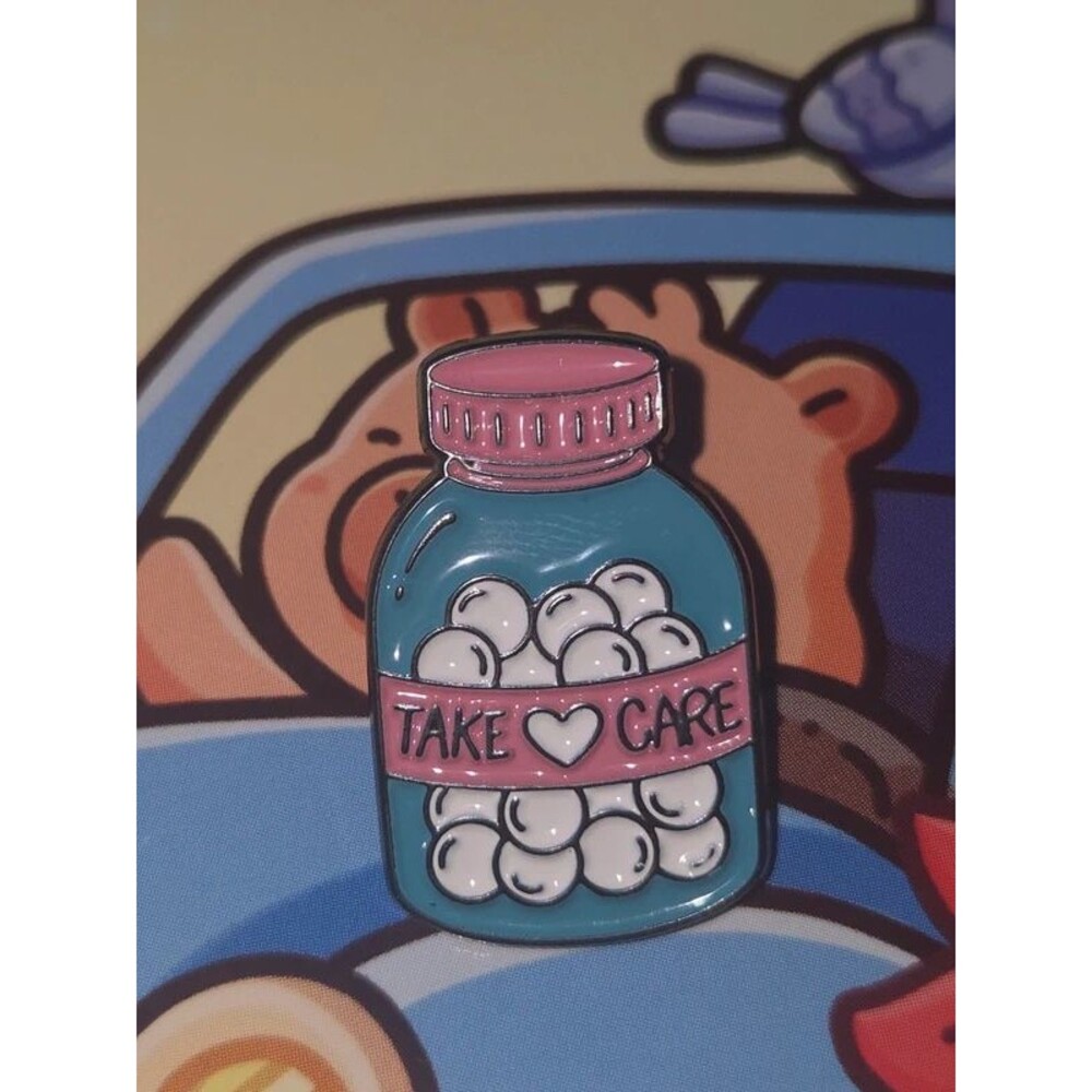 Take care of pink and blue enamel pin